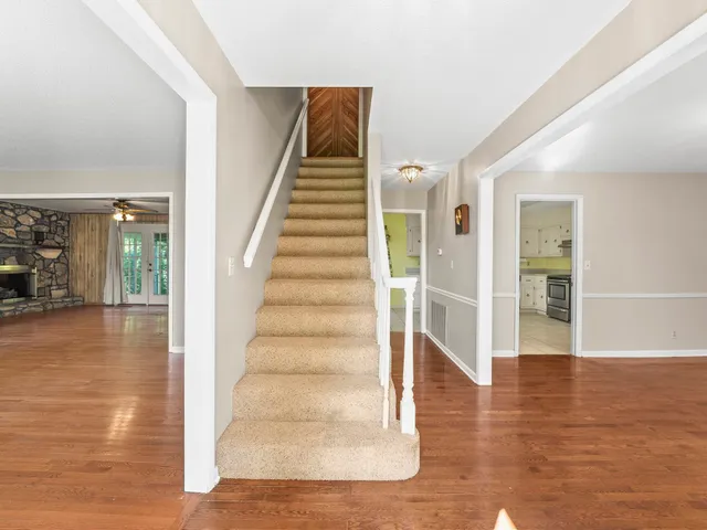 a view of a hallway with wooden floor and entryway
