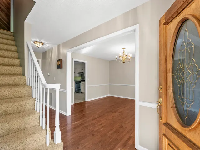 a view of an empty room with stairs and ventilation