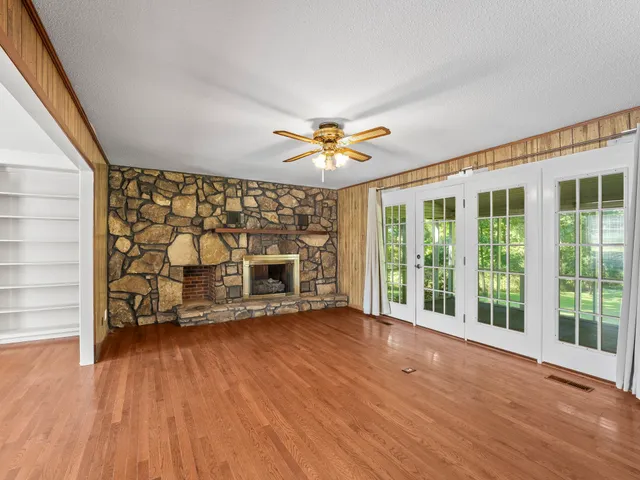a view of a livingroom with a ceiling fan and window