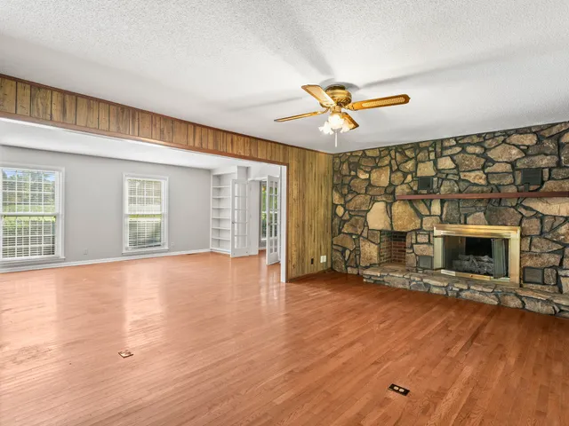 a kitchen with white cabinets a window and stainless steel appliances