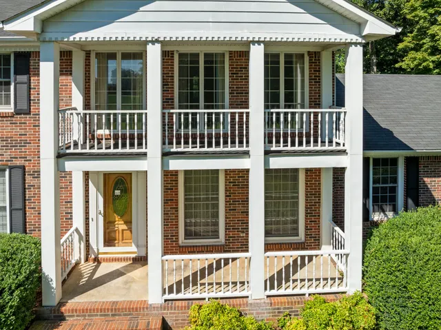 a view of a brick house with large windows