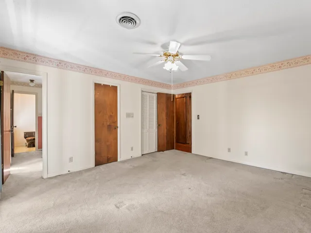 an empty room with windows and entrance