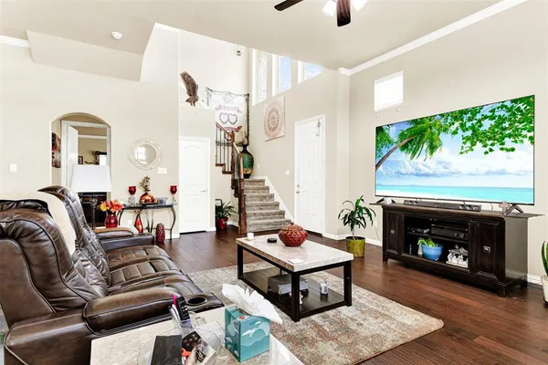 a living room with furniture a wooden floor and a window