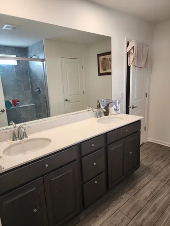 a bathroom with a double vanity sink and a mirror
