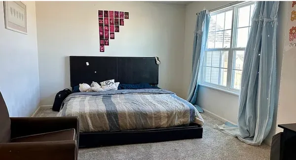 a bedroom with bed and window
