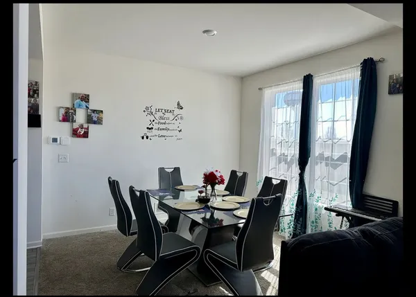 a view of a dining room with furniture and window