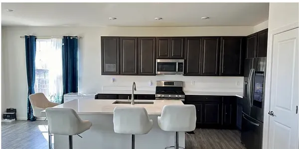 a kitchen with a sink cabinets and window