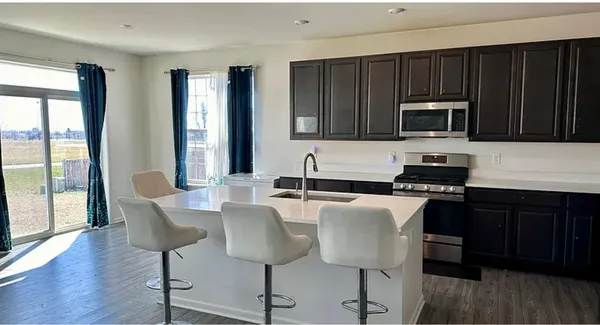 a kitchen with stainless steel appliances wooden cabinets and a stove top oven