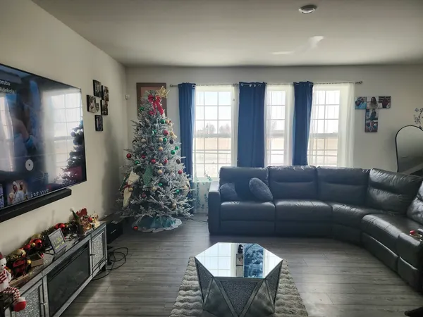 a living room with furniture window and wooden floor