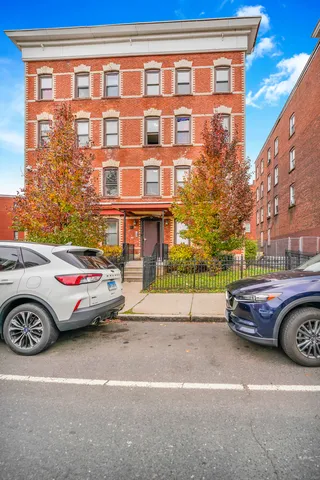a front view of a house with parking space