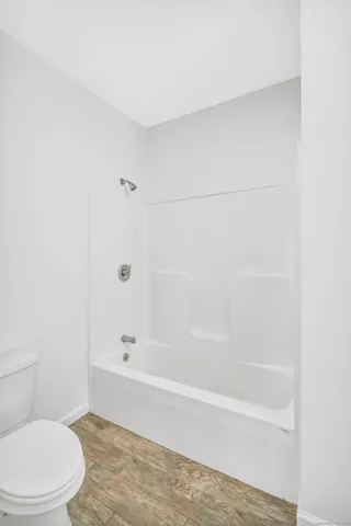 a bathroom with a bathtub and a toilet