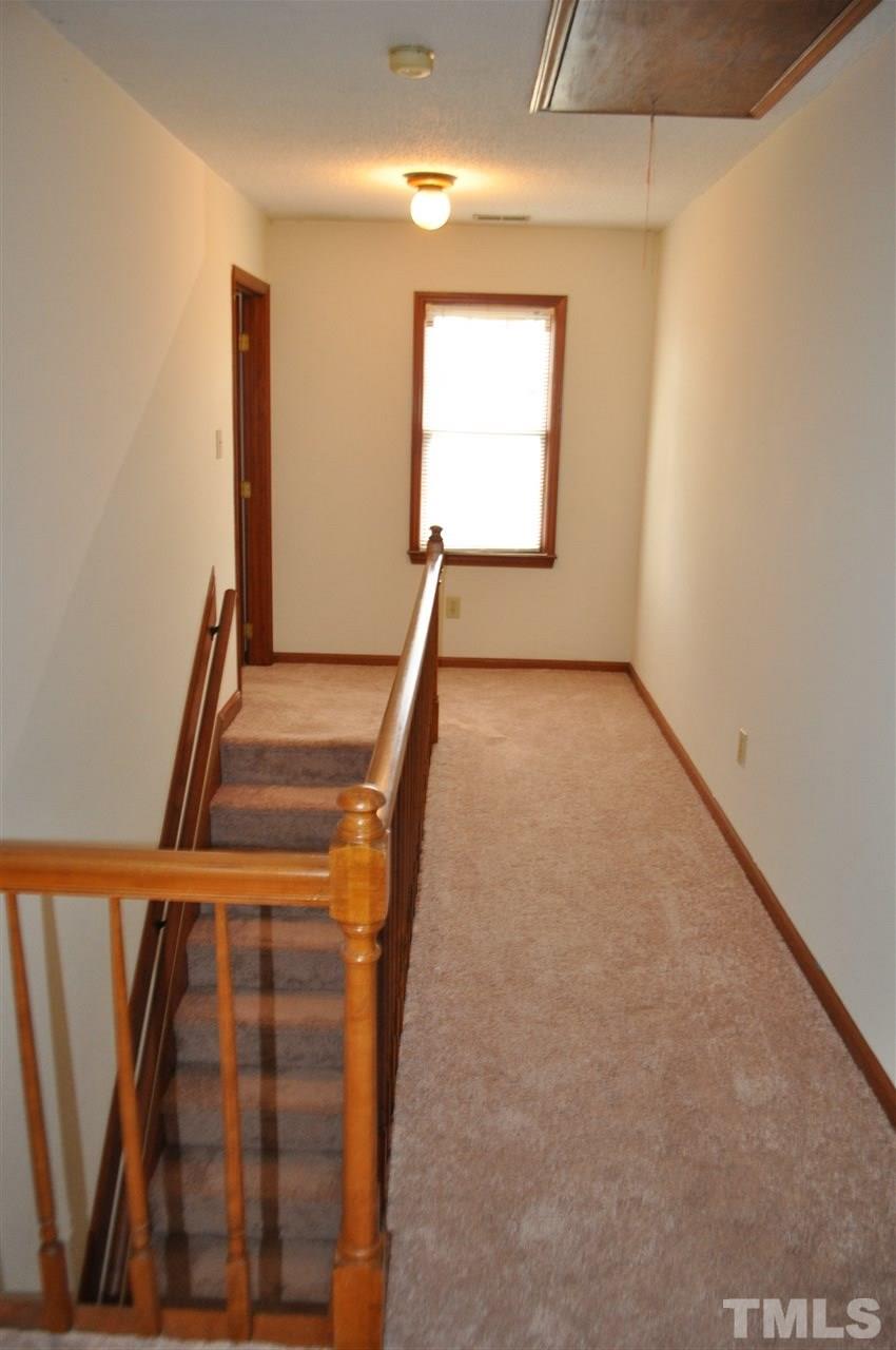 13465 Cleveland Road Garner, NC 27529 - Photo 23 of 30 Spacious and bright upstairs hallway with pull down attic access