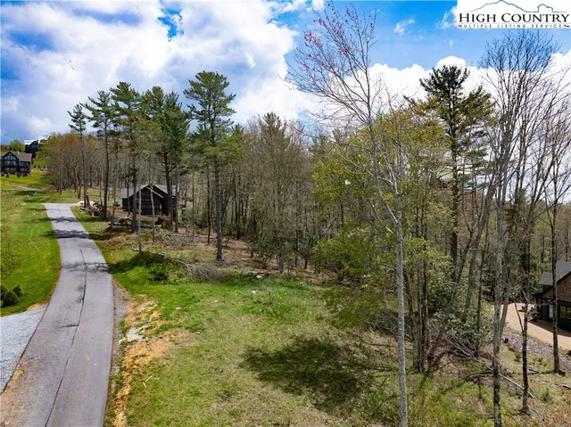 a view of swimming pool with a table and chairs