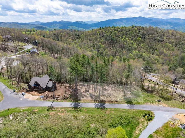 a view of a garden with a building in the background