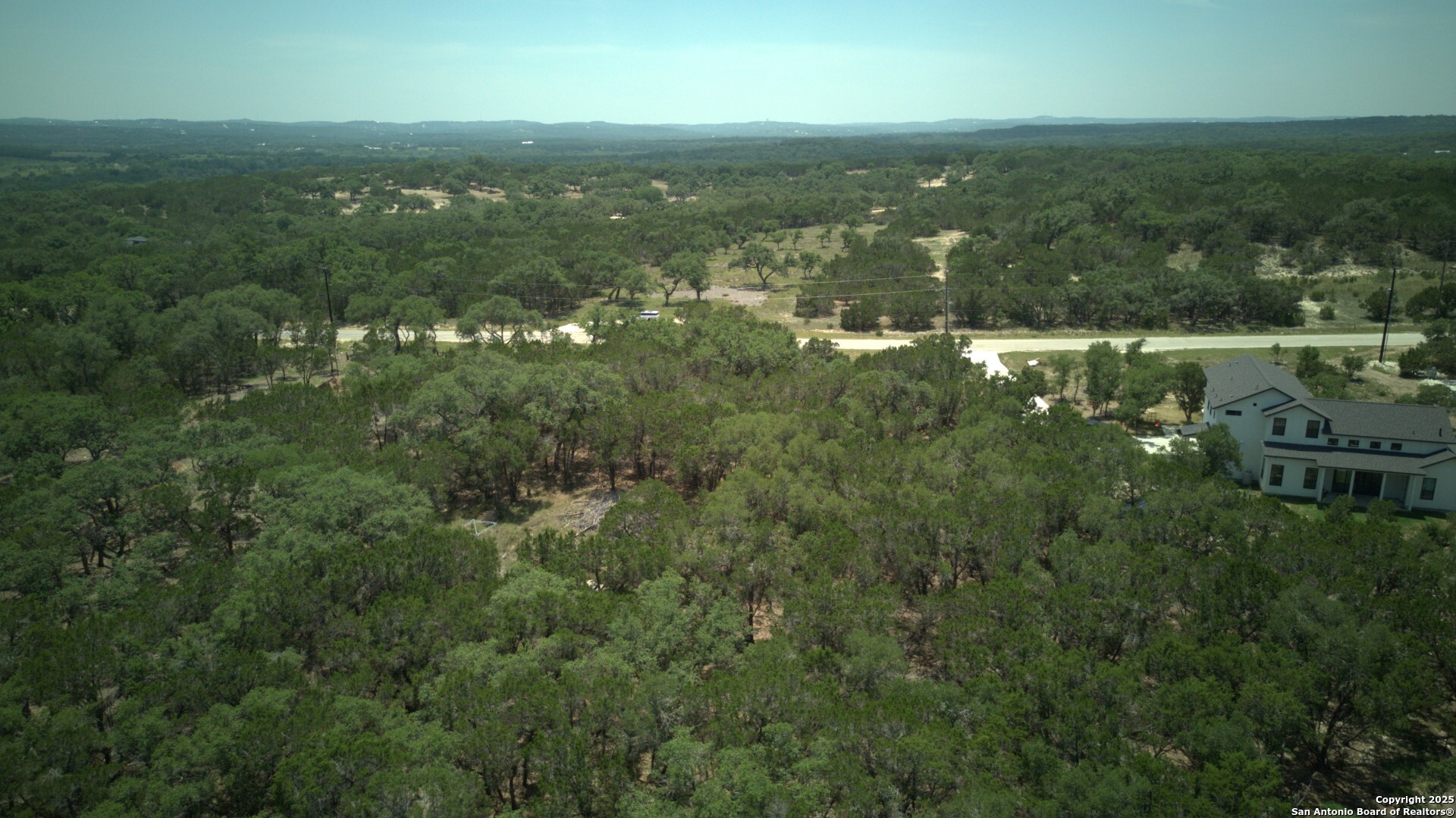 265 Restless Wind Spring Branch, TX 78070 - Photo 5 of 8 a view of a city with lush green forest