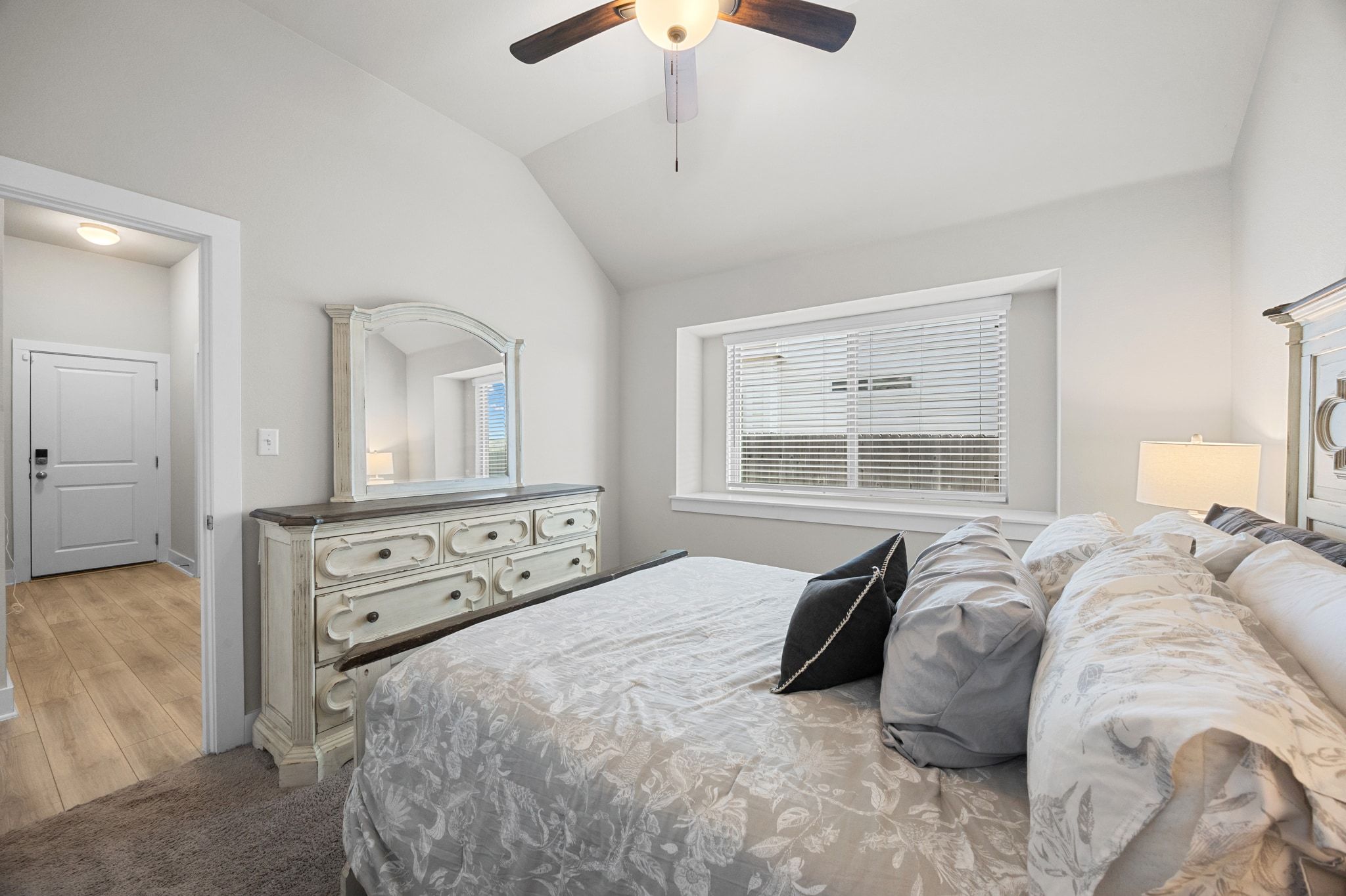 4807 Portillo Way Pflugerville, TX 78660 - Photo 16 of 24 Bedroom with vaulted ceiling, a ceiling fan, and dark carpet