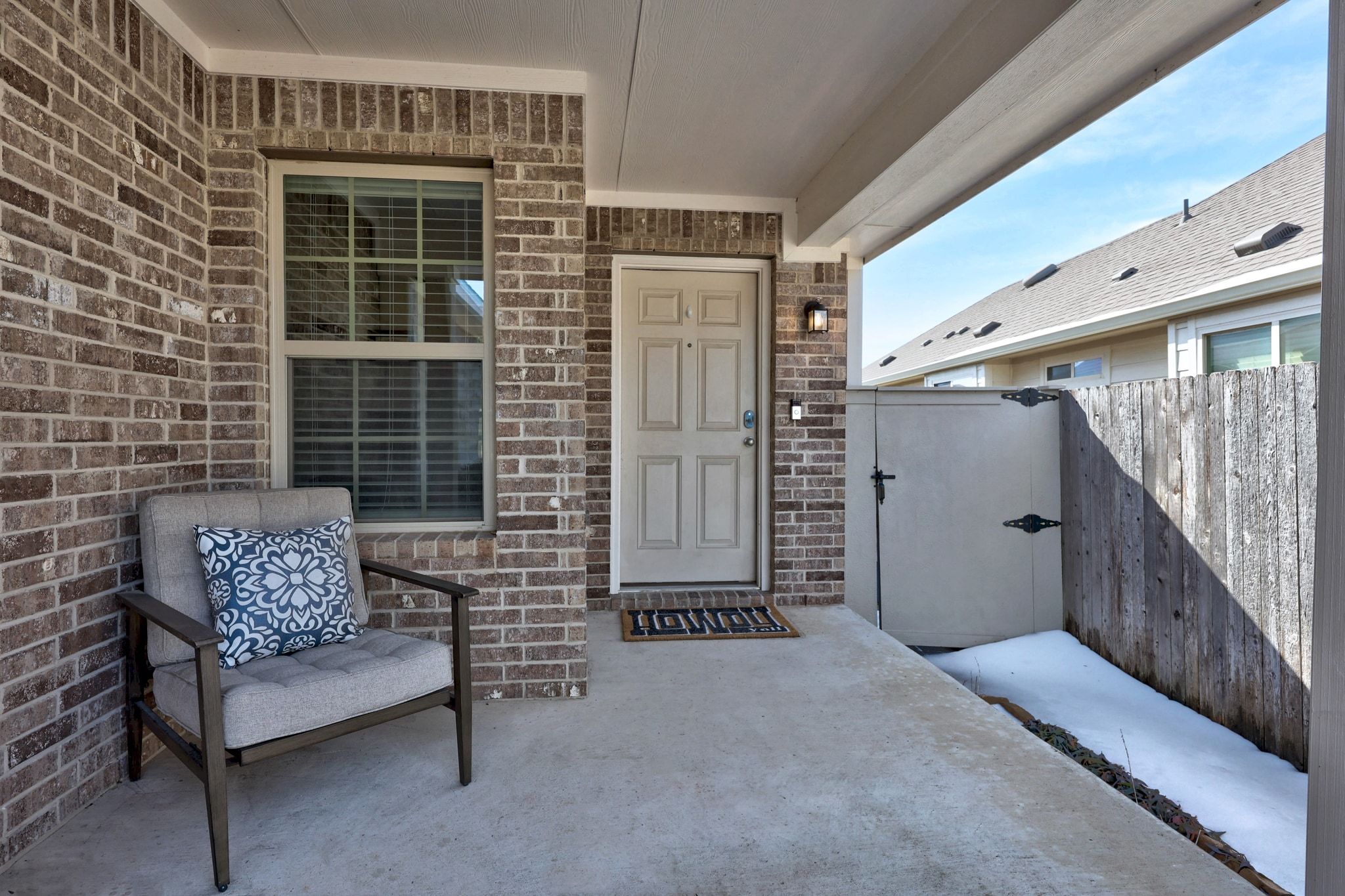 4807 Portillo Way Pflugerville, TX 78660 - Photo 2 of 24 Property entrance with a gate, brick siding, and a patio area