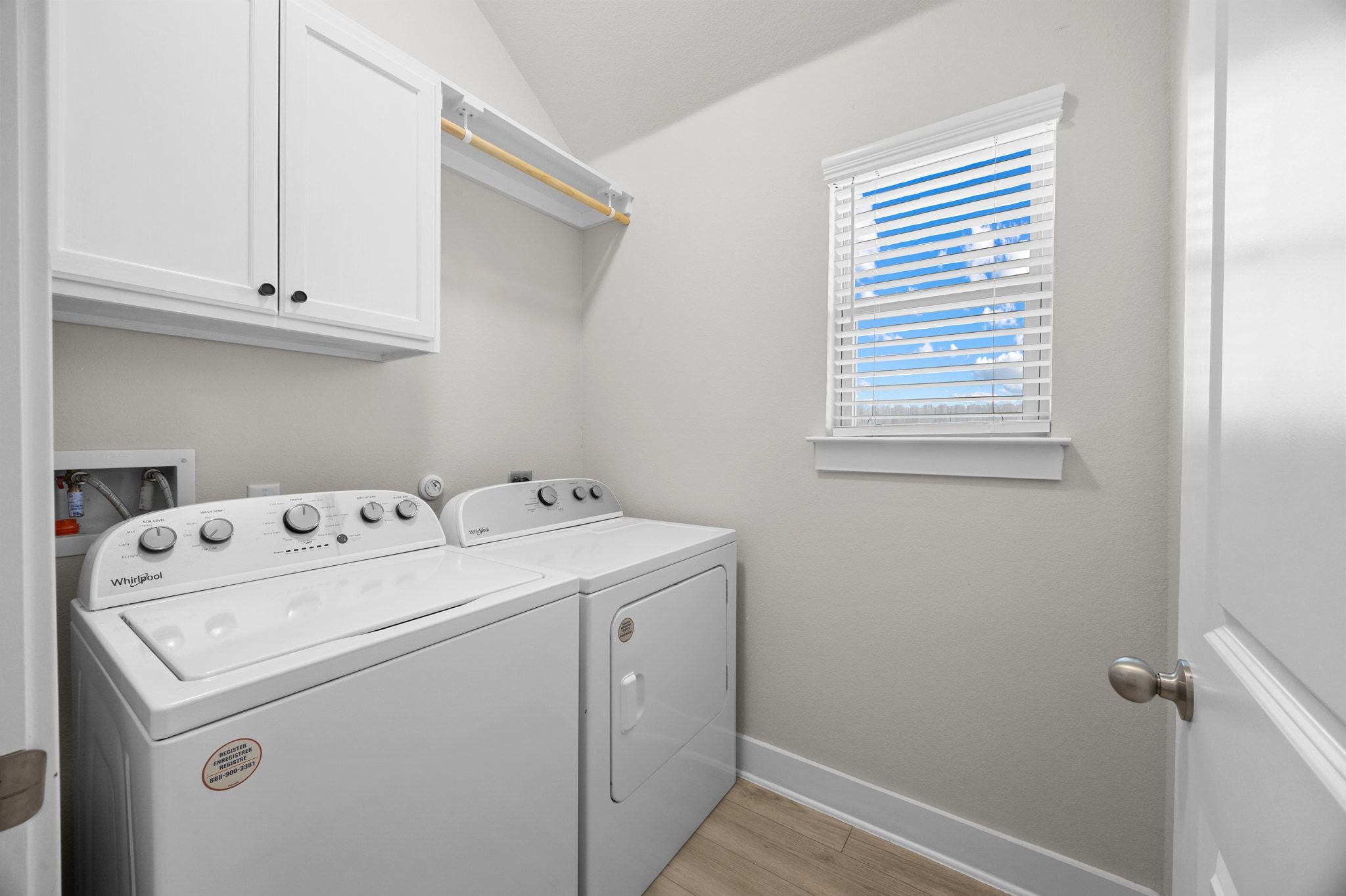 4807 Portillo Way Pflugerville, TX 78660 - Photo 20 of 24 Laundry area with light wood-style floors, washer and clothes dryer, cabinet space, and lofted ceiling