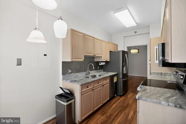 a kitchen with a sink stove and refrigerator