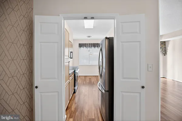 a view of a hallway with wooden floor and staircase
