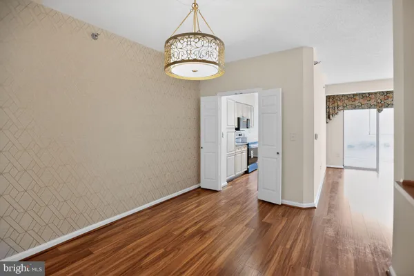 a view of a room with wooden floor