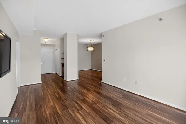 a view of a room with wooden floor and brick wall