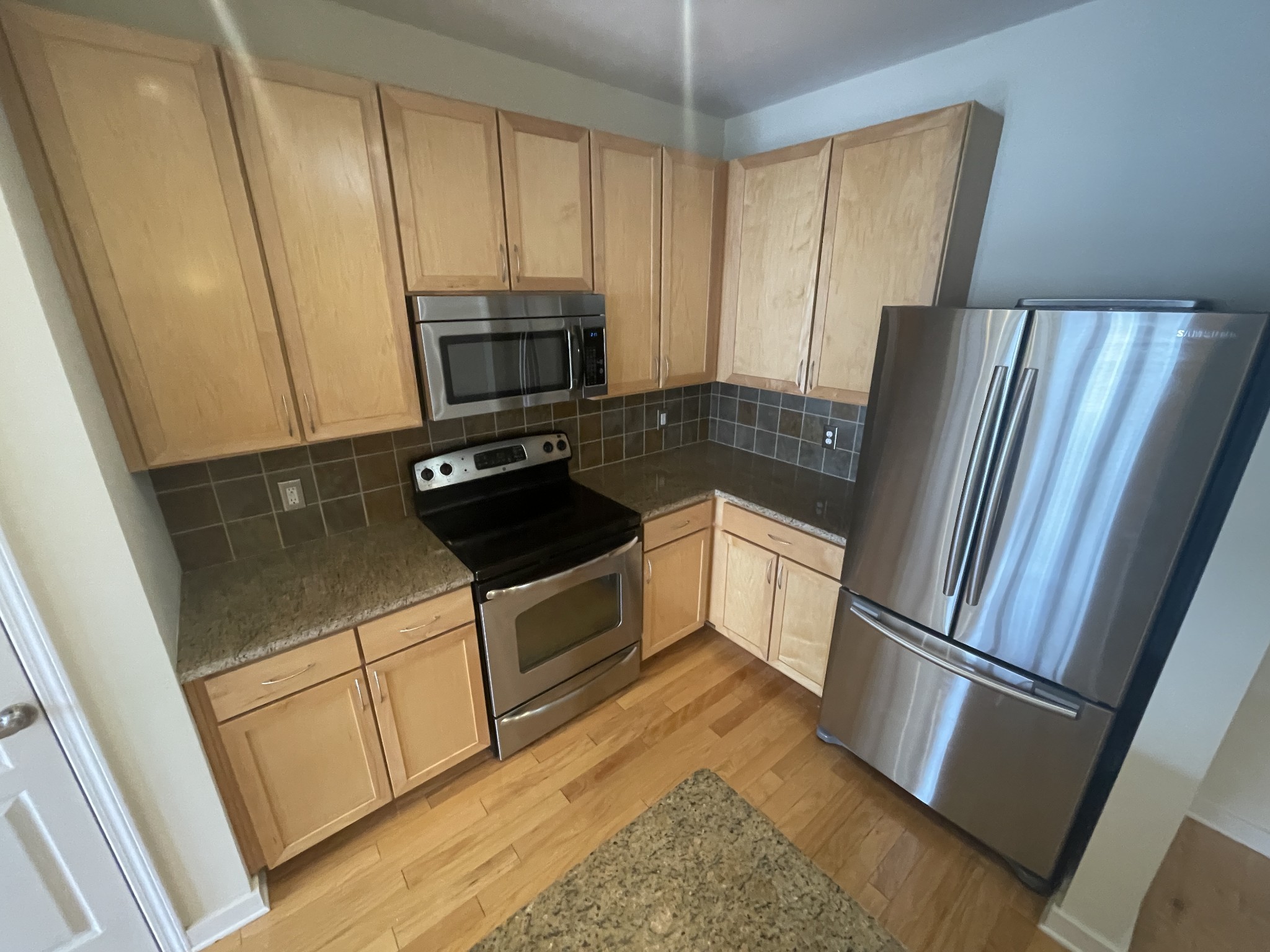 3000 Vanderbilt Place, Unit 412 Nashville, TN 37212 - Photo 3 of 13 a kitchen with a refrigerator sink and microwave