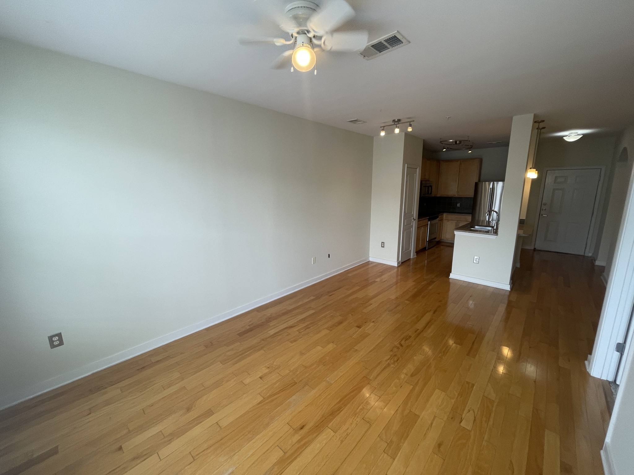 3000 Vanderbilt Place, Unit 412 Nashville, TN 37212 - Photo 6 of 13 wooden floor in an empty room with a bathroom