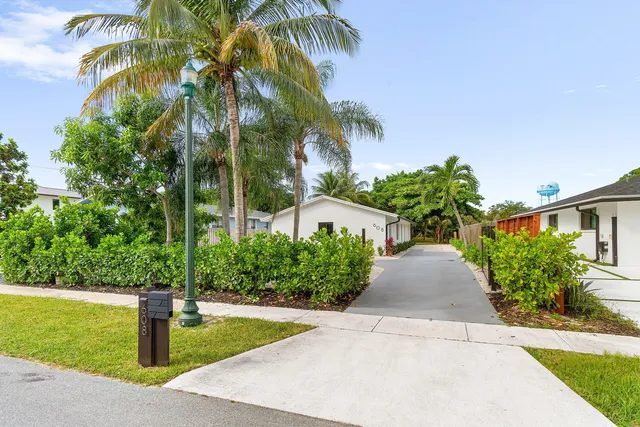 a kitchen with stainless steel appliances granite countertop a sink and a refrigerator