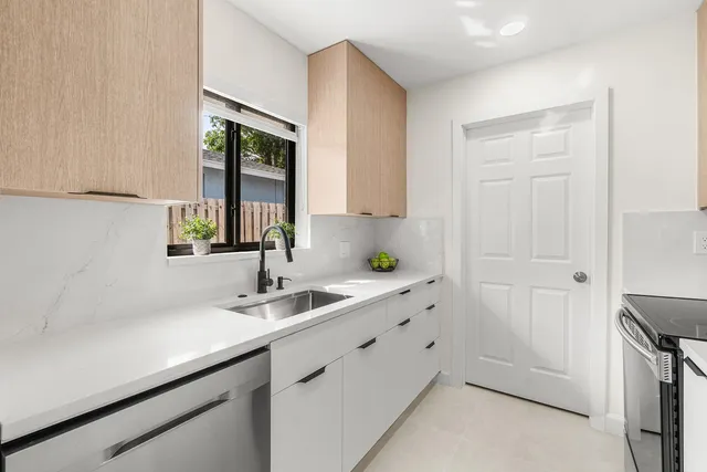 a walk in closet with a large window and stainless steel appliances