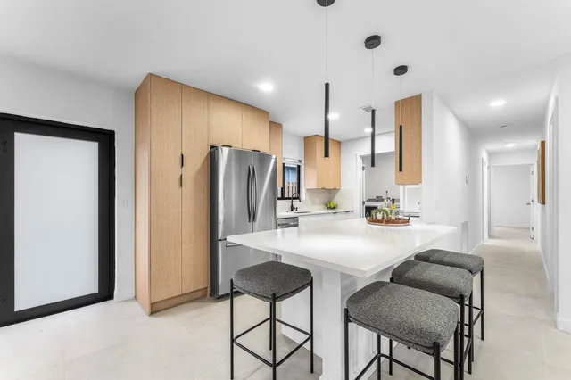 a spacious bedroom with a bed and a lamp