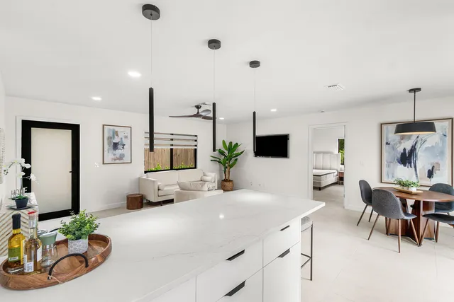 a spacious bedroom with a bed and a cabinets