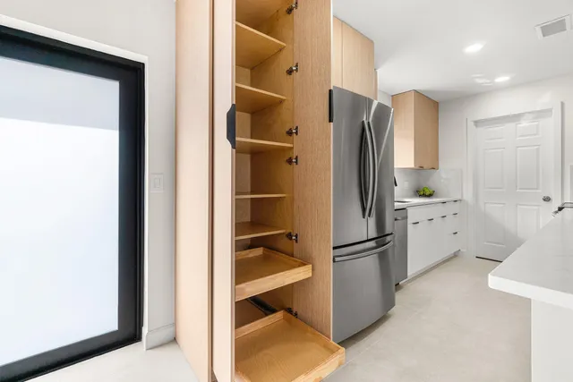 a bathroom with a granite countertop toilet sink mirror and window