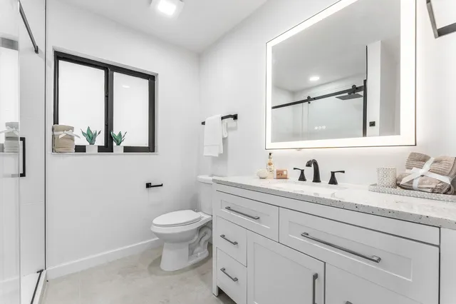 a bedroom with two beds and a window