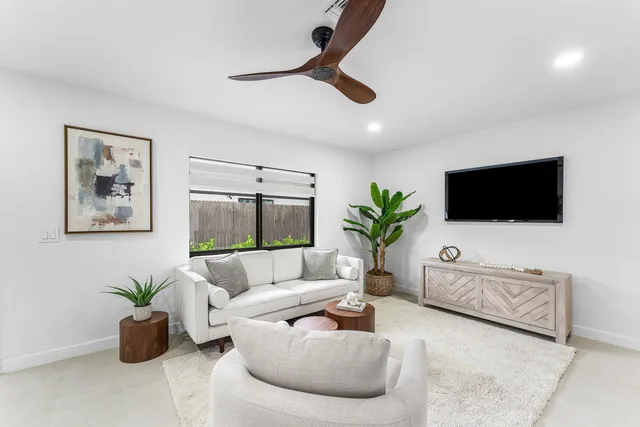a living room with furniture kitchen and a chandelier