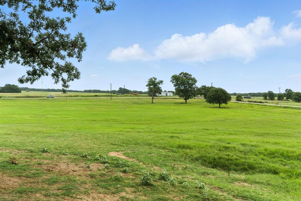 0 Division Lane Poolville, TX 76487 - Photo 10 of 11 a view of a big yard with an trees