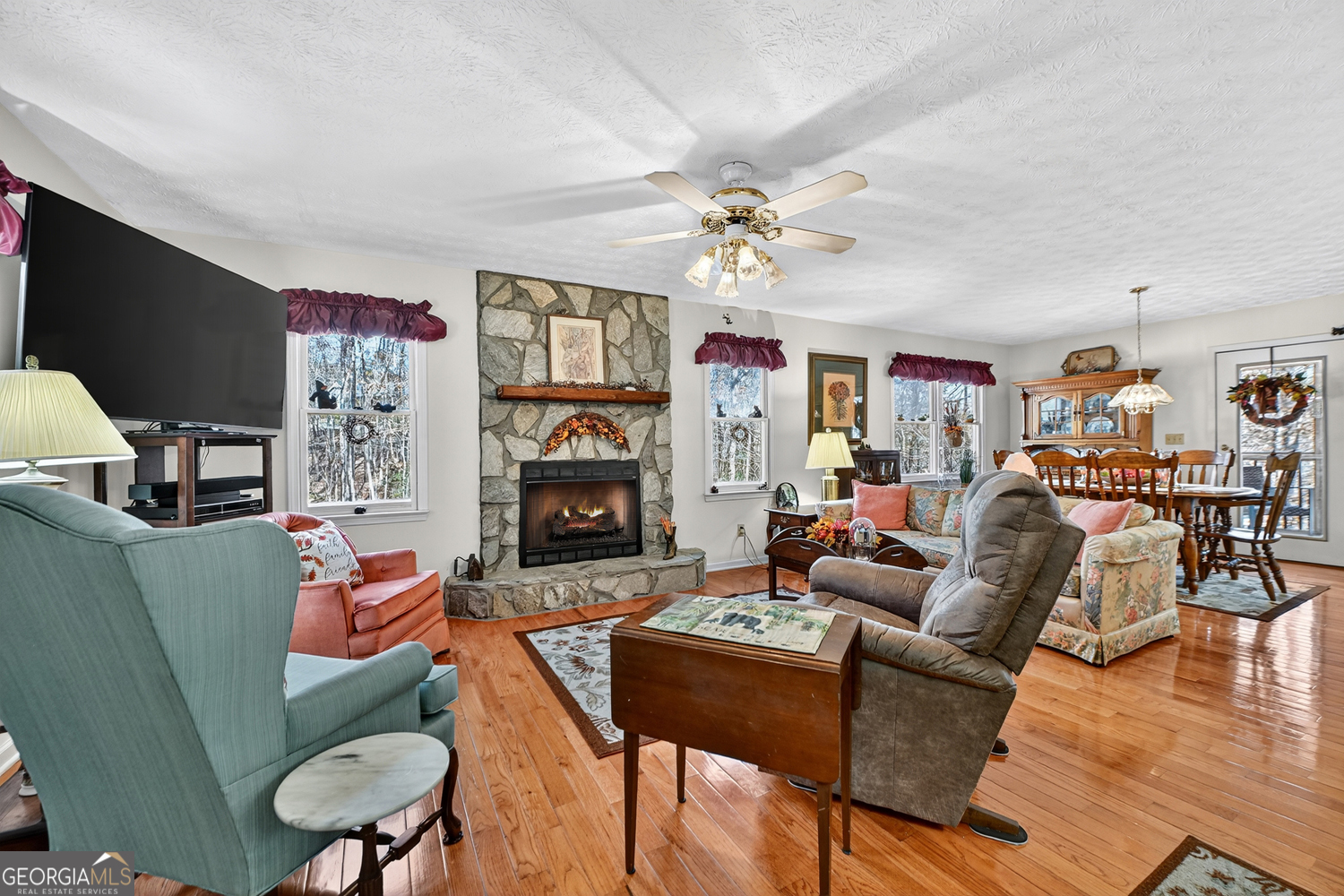 122 D D J Lane Ellijay, GA 30540 - Photo 17 of 51 a living room with furniture a flat screen tv and a fireplace