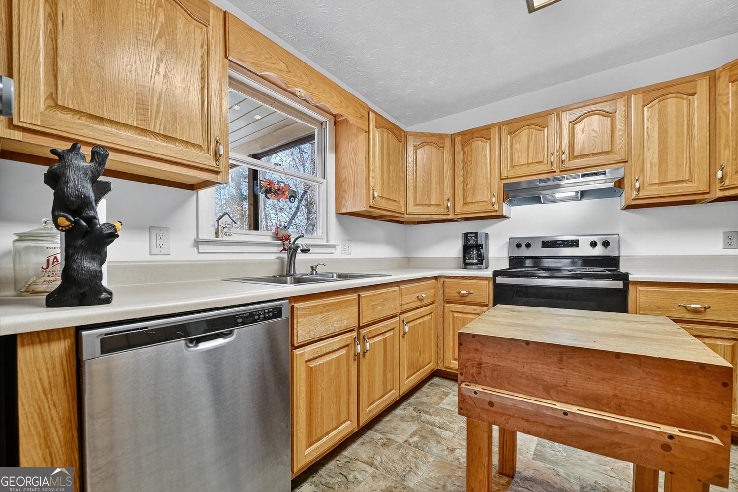 122 D D J Lane Ellijay, GA 30540 - Photo 25 of 51 a kitchen with stainless steel appliances granite countertop a sink stove and cabinets