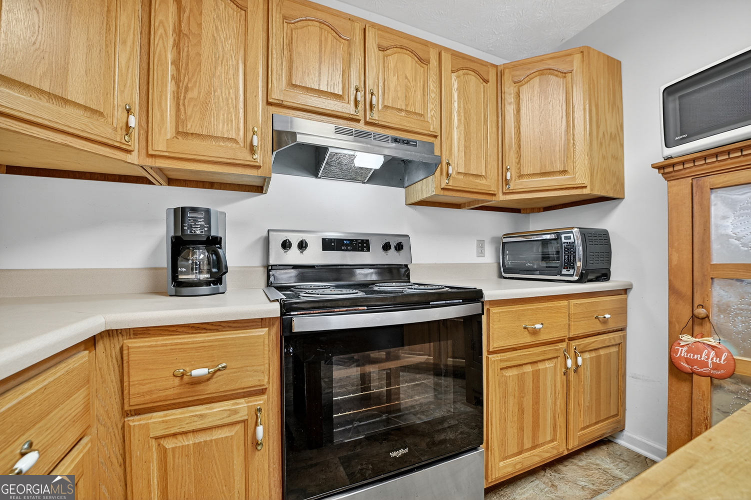 122 D D J Lane Ellijay, GA 30540 - Photo 26 of 51 a kitchen with granite countertop cabinets stainless steel appliances and wooden cabinets
