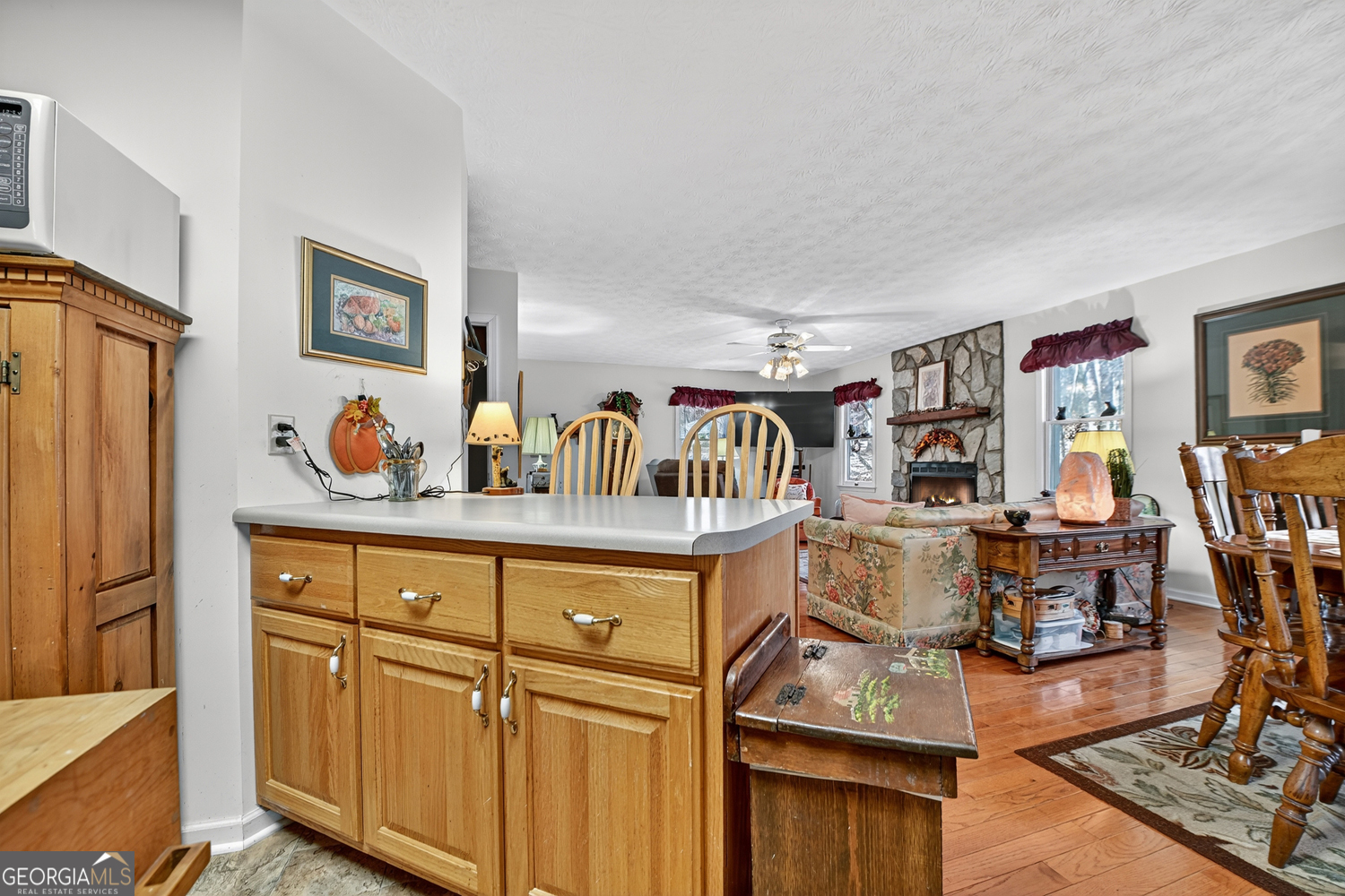 122 D D J Lane Ellijay, GA 30540 - Photo 27 of 51 a living room with furniture a flat screen tv and kitchen view