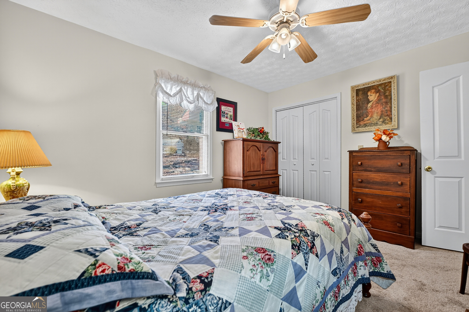 122 D D J Lane Ellijay, GA 30540 - Photo 30 of 51 a bedroom with a bed and a chandelier