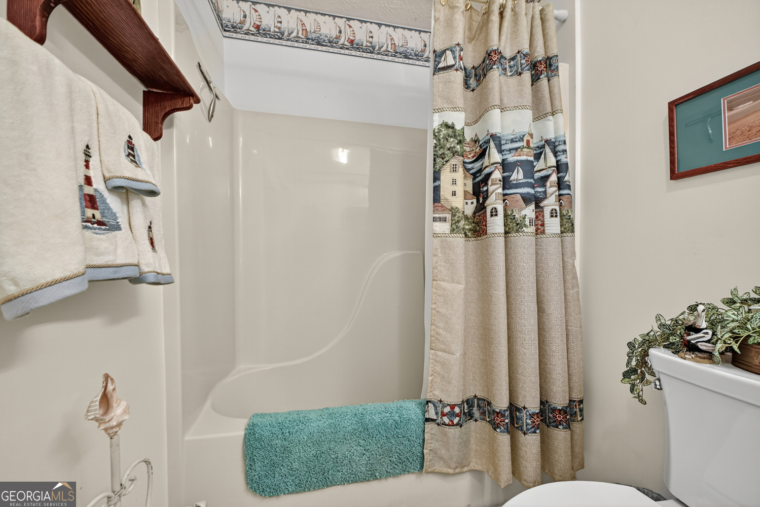 122 D D J Lane Ellijay, GA 30540 - Photo 32 of 51 a bathroom with a shower curtain