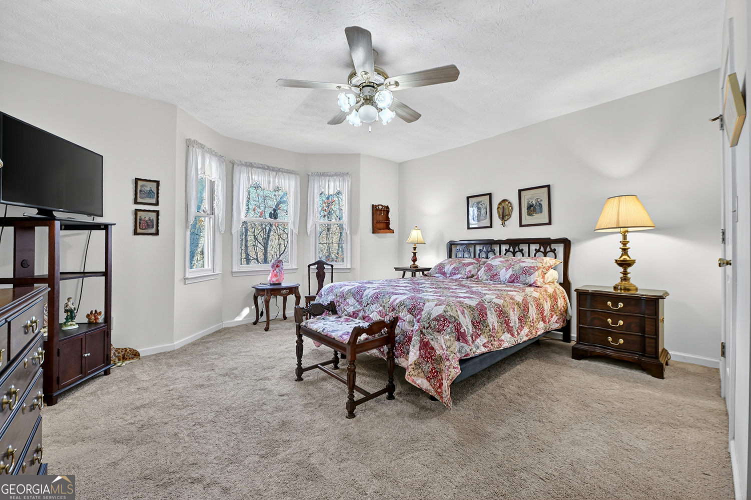 122 D D J Lane Ellijay, GA 30540 - Photo 33 of 51 a spacious bedroom with a bed and a flat screen tv