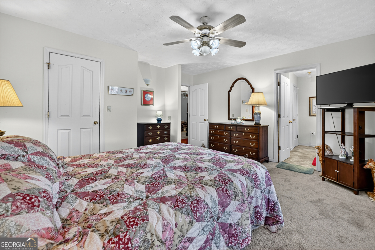 122 D D J Lane Ellijay, GA 30540 - Photo 35 of 51 a spacious bedroom with a bed and a flat screen tv