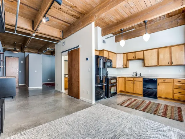 a kitchen with stainless steel appliances granite countertop a sink and cabinets