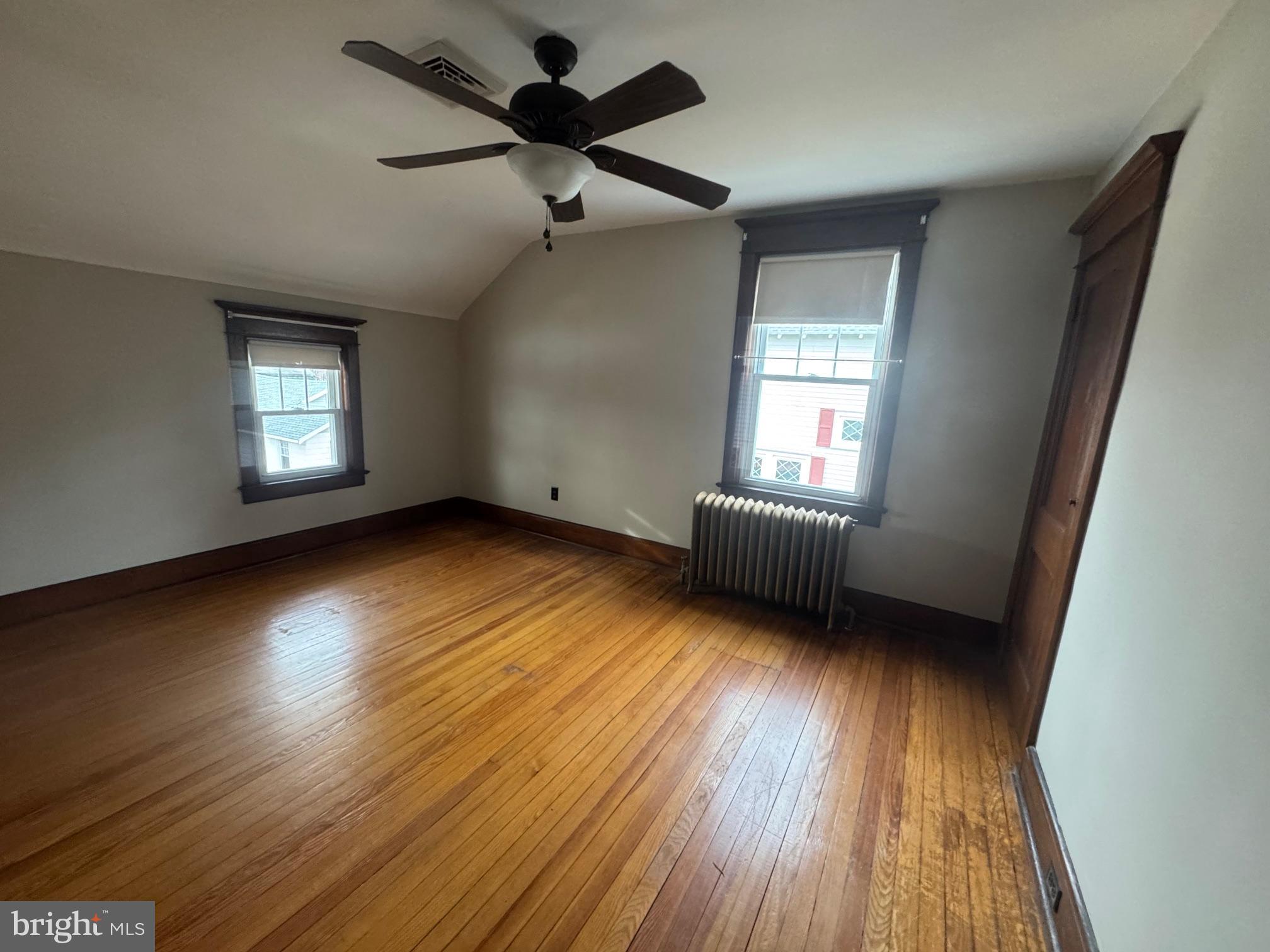 307 Edgewood Avenue Delanco, NJ 08075 - Photo 9 of 13 an empty room with wooden floor and windows
