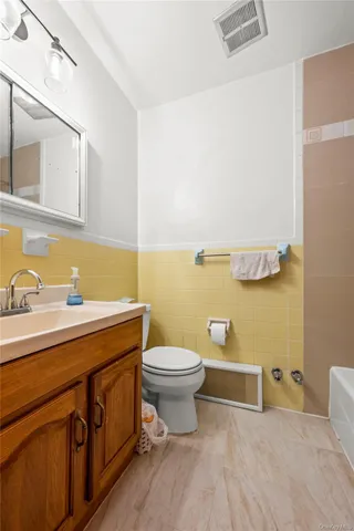 a bathroom with a sink a toilet and mirror