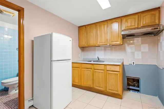 a white refrigerator freezer sitting in a kitchen