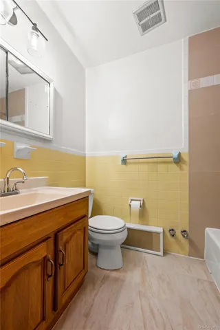 a bathroom with a sink a toilet and mirror