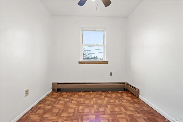a view of a room with wooden floor and a window